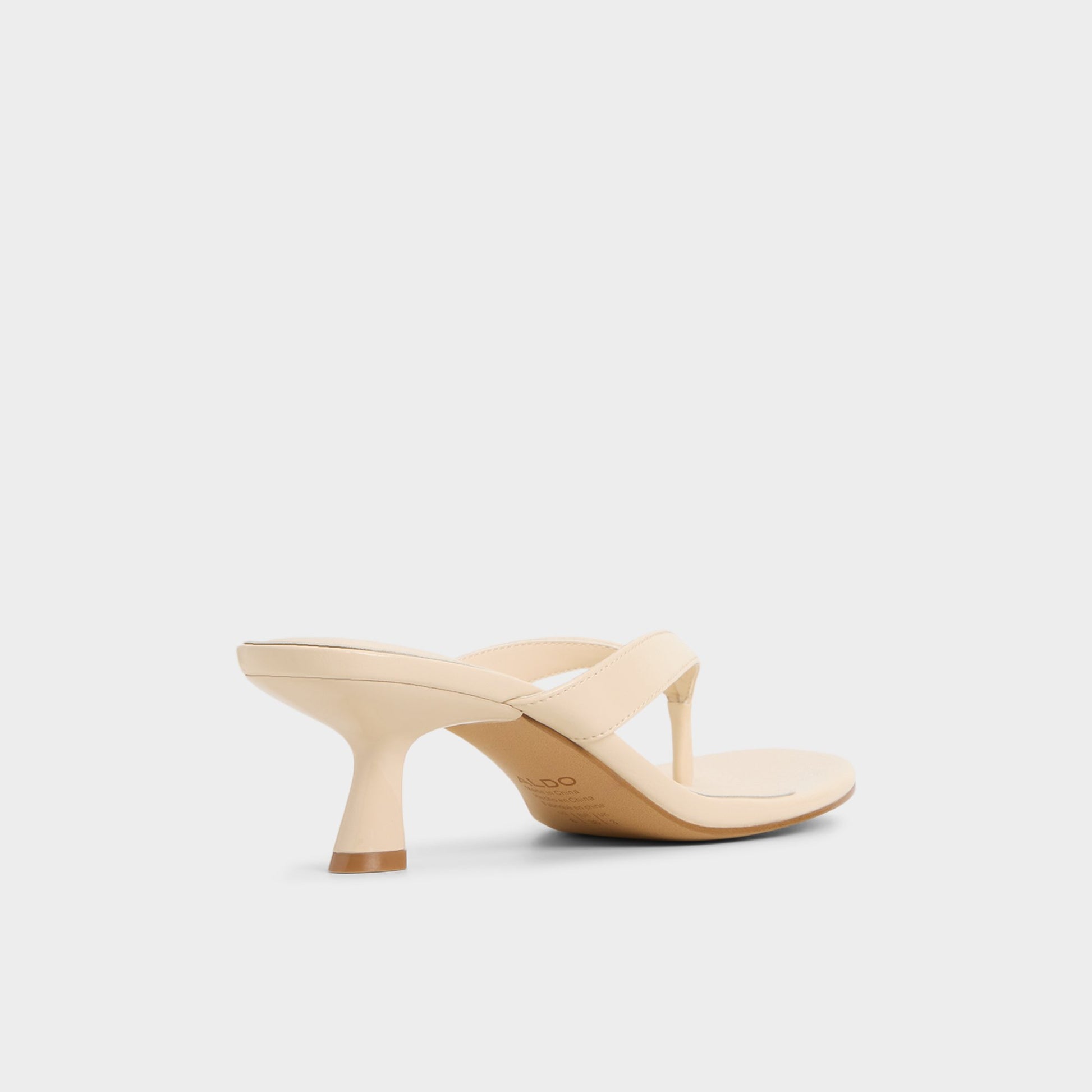Three-quarter angle of Cream Jump Heeled flip flop's back side