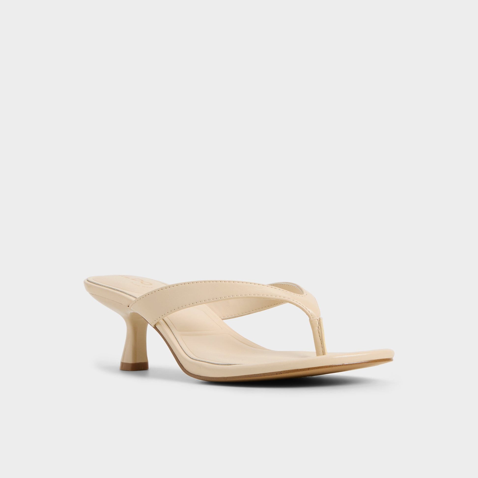 Three-quarter angle of Cream Jump Heeled flip flop's front side