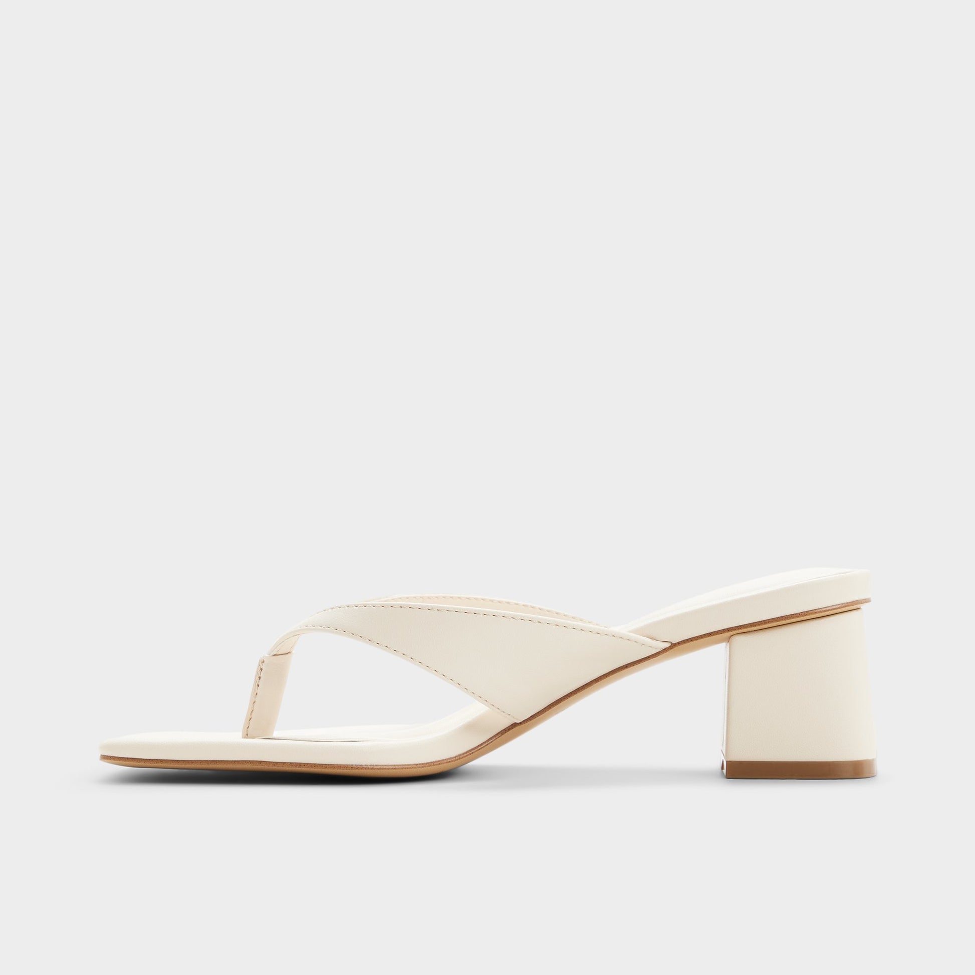 Side view of Other white Antonina Block heeled flip flop