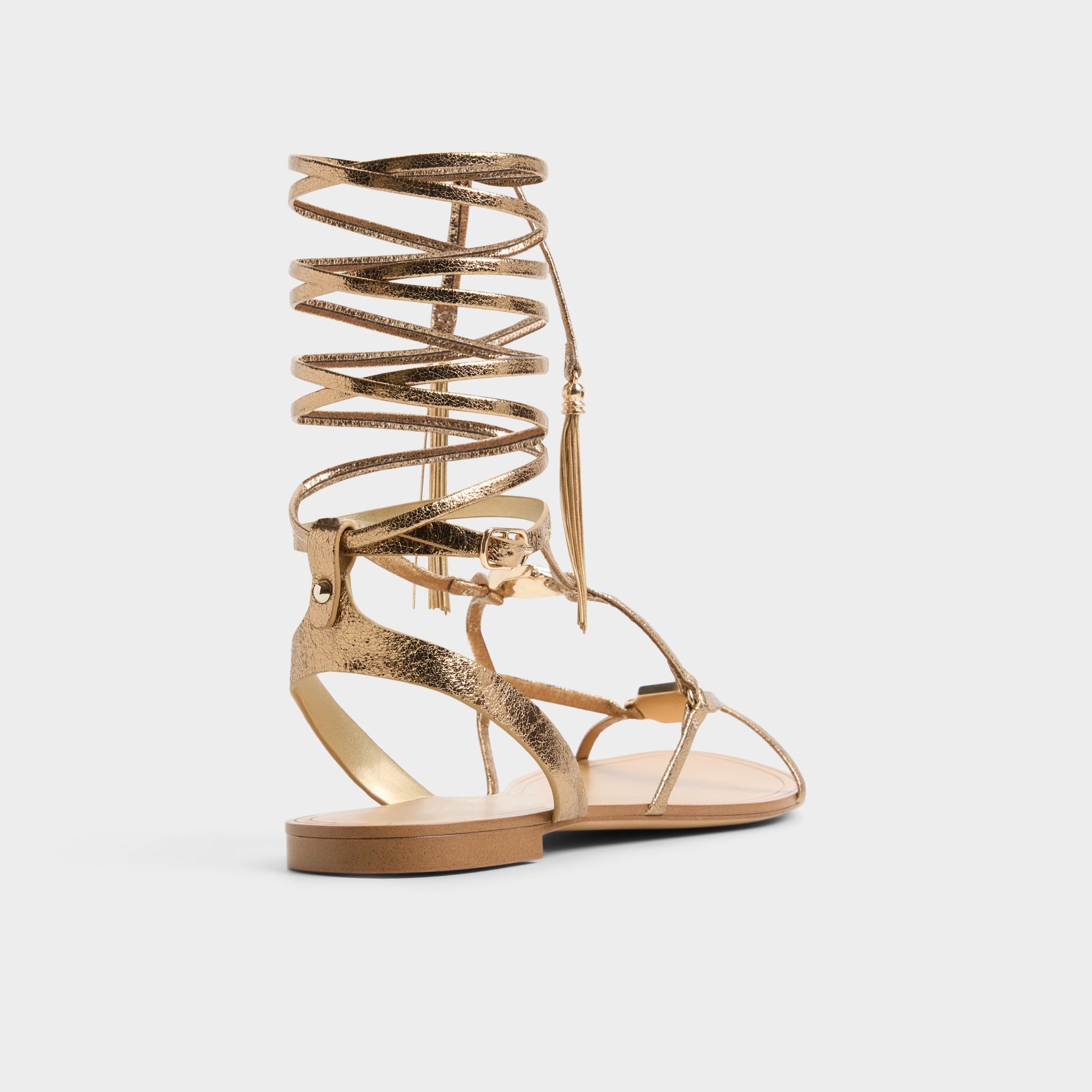 Three-quarter angle of Gold Andrina Strappy flat sandal's back side