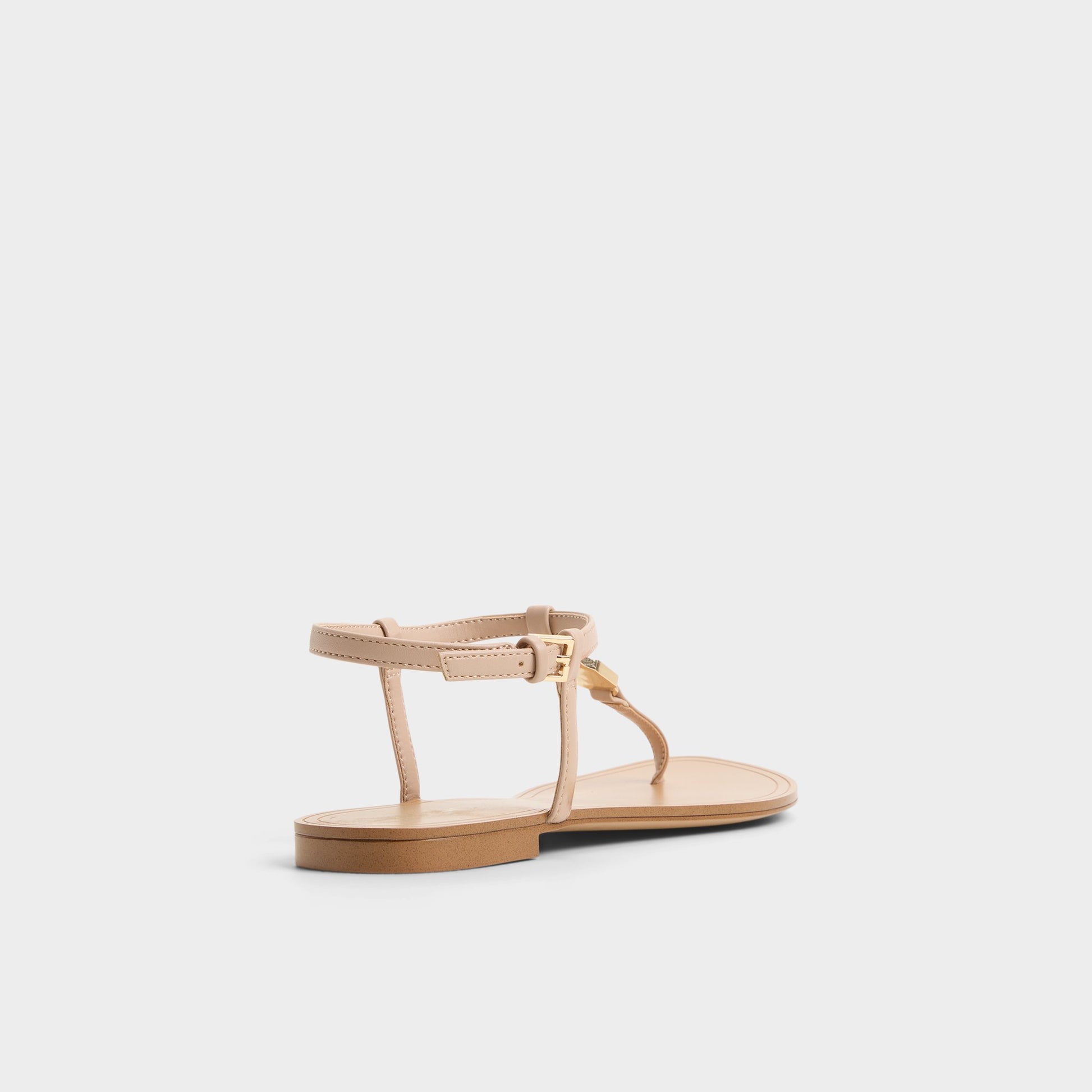 Three-quarter angle of Beige Sandstone T-strap sandal's back side