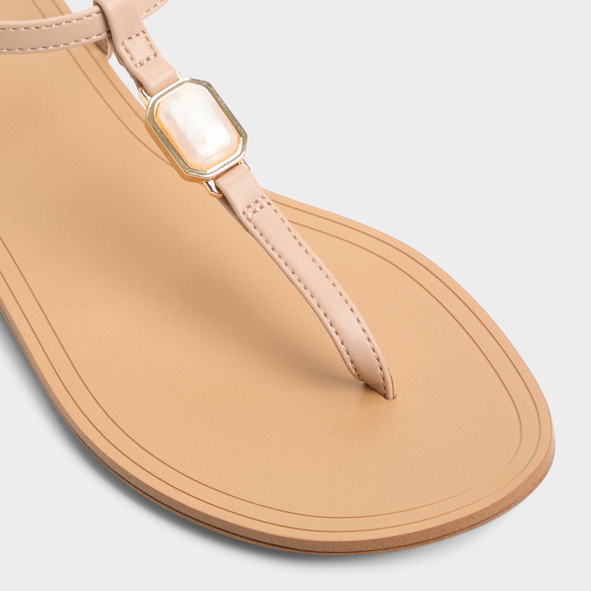 Close-up of the Beige Sandstone T-strap sandal
