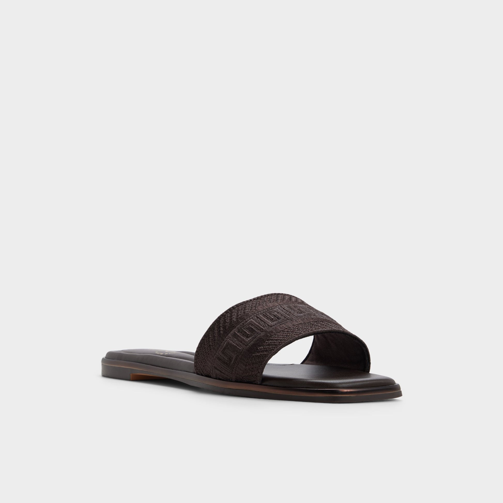 Three-quarter angle of Dark brown Oceania Slide sandal's front side
