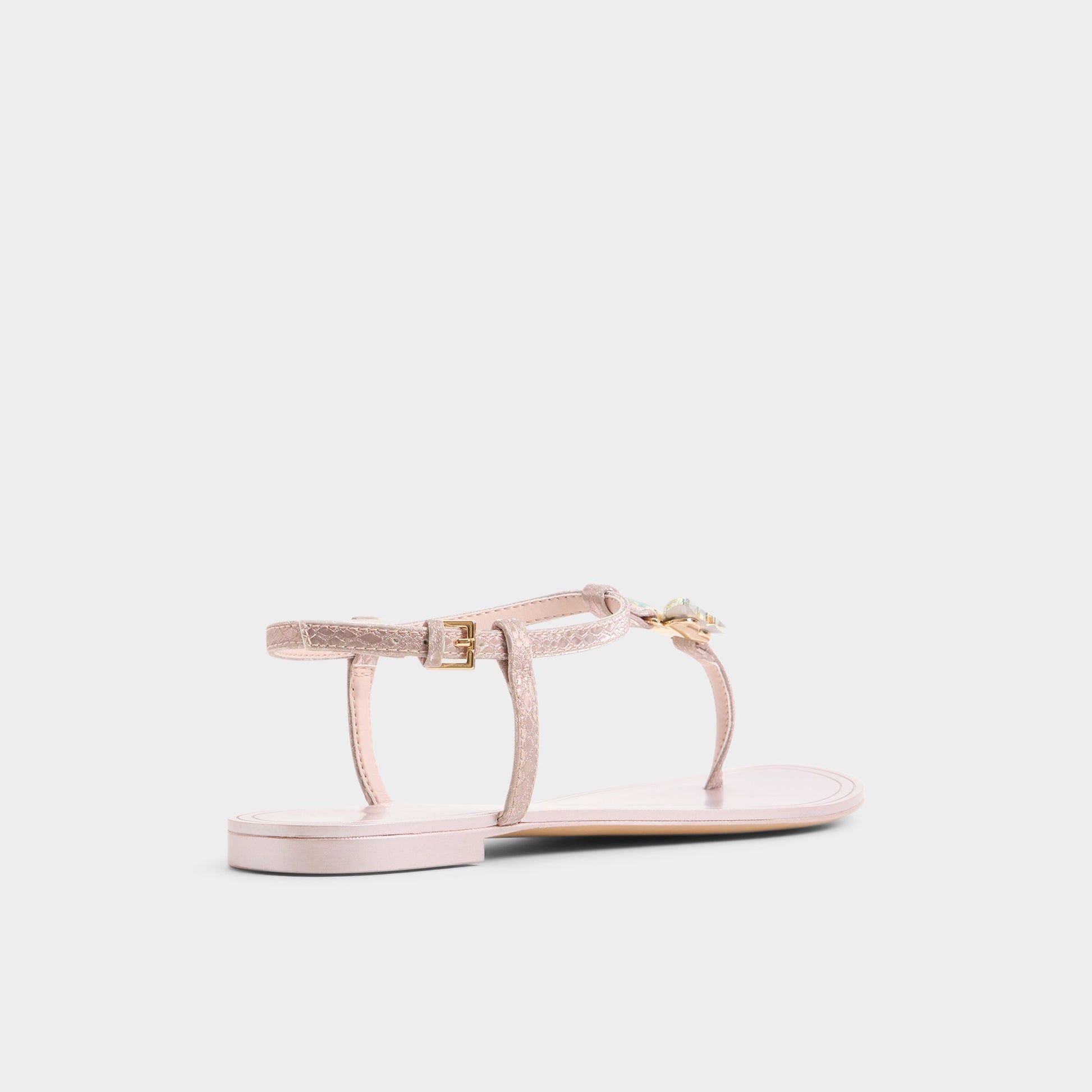 Three-quarter angle of Rose gold Farfallina T-strap sandal's back side