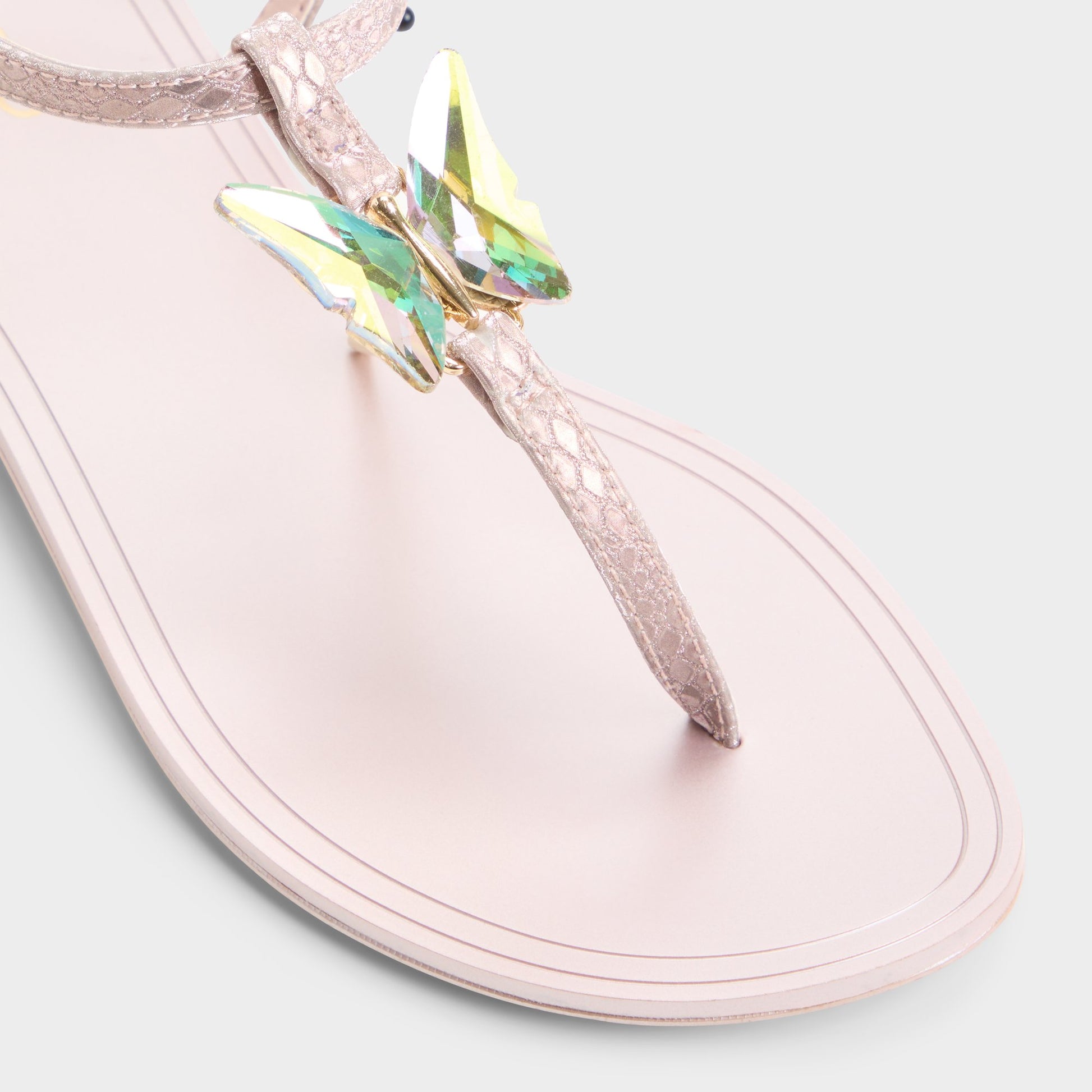 Close-up of the Rose gold Farfallina T-strap sandal