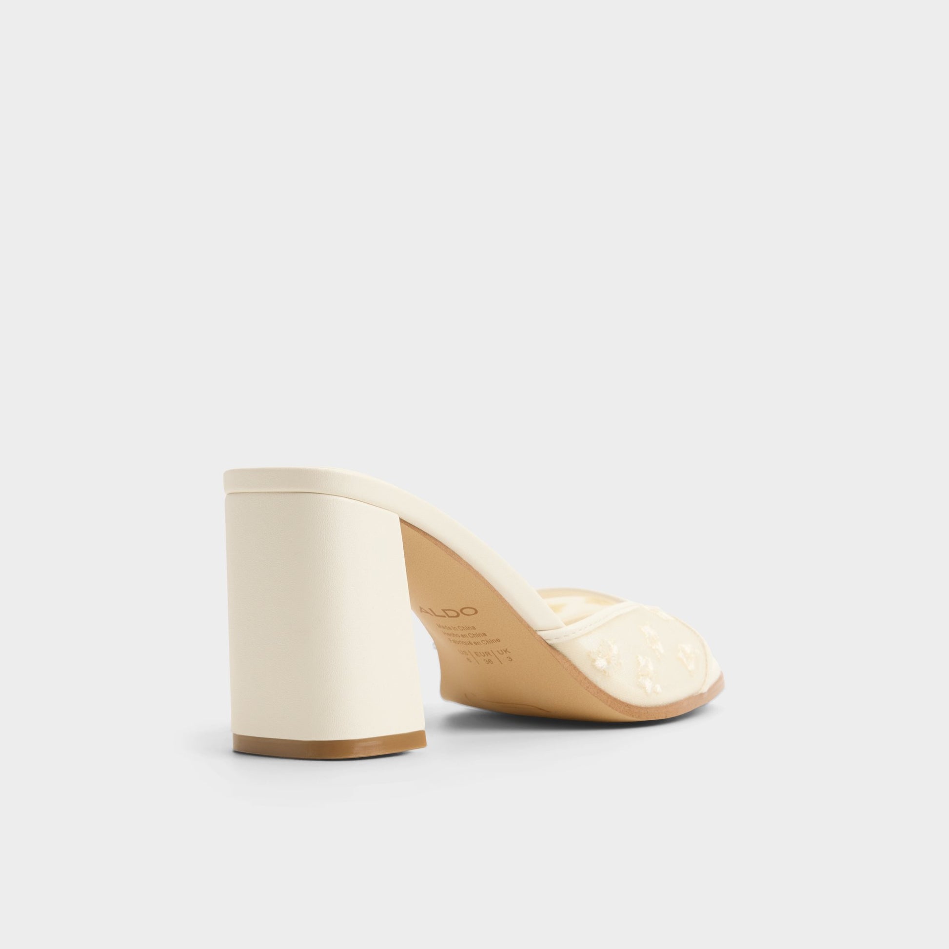 Three-quarter angle of Other white Lisarae Heeled mule's back side