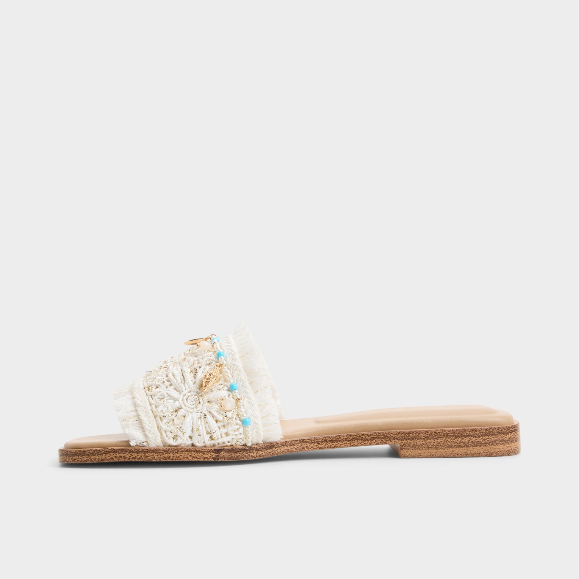 Side view of White/bone Aurana Slide sandal