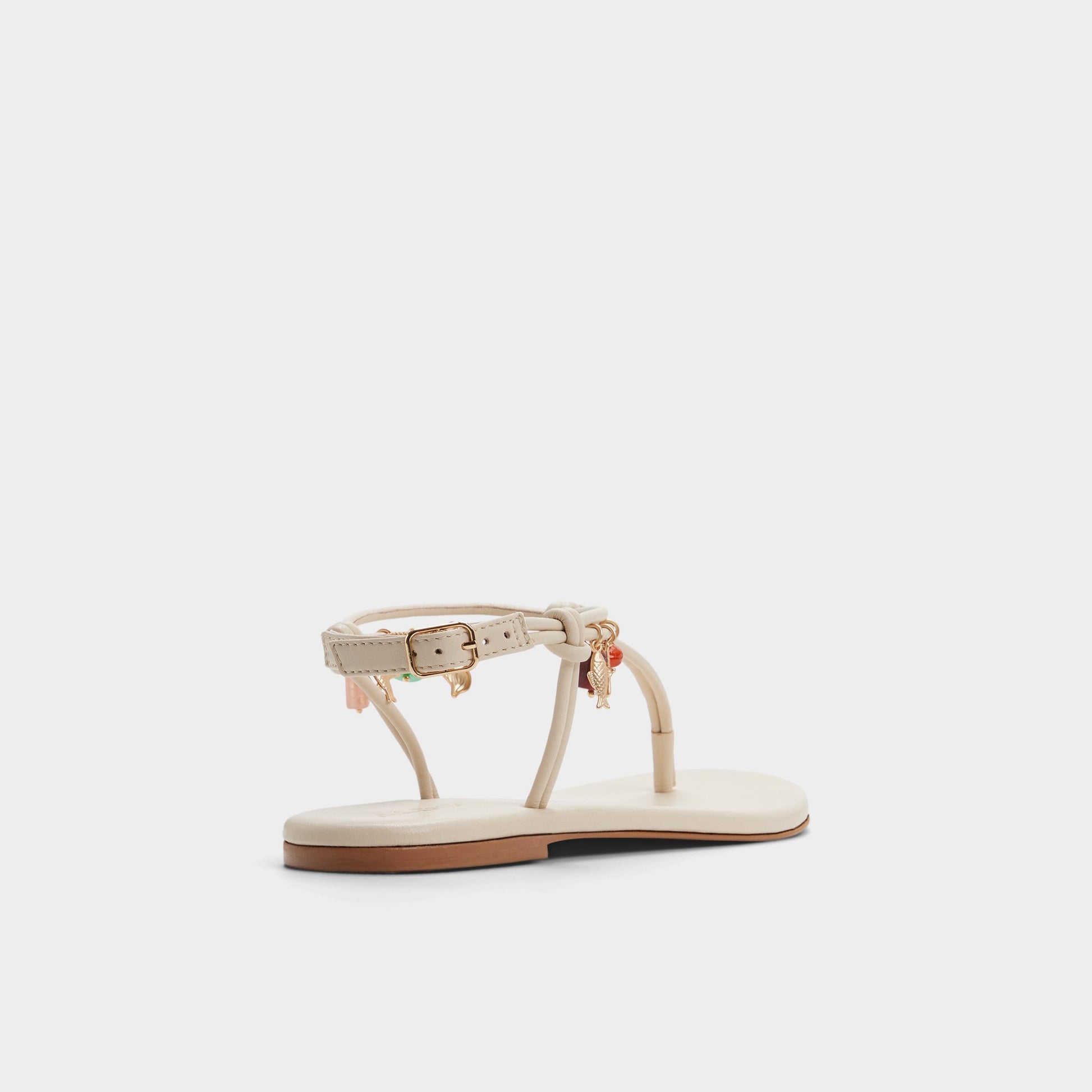 Three-quarter angle of White/bone Seajewels T-strap sandal's back side