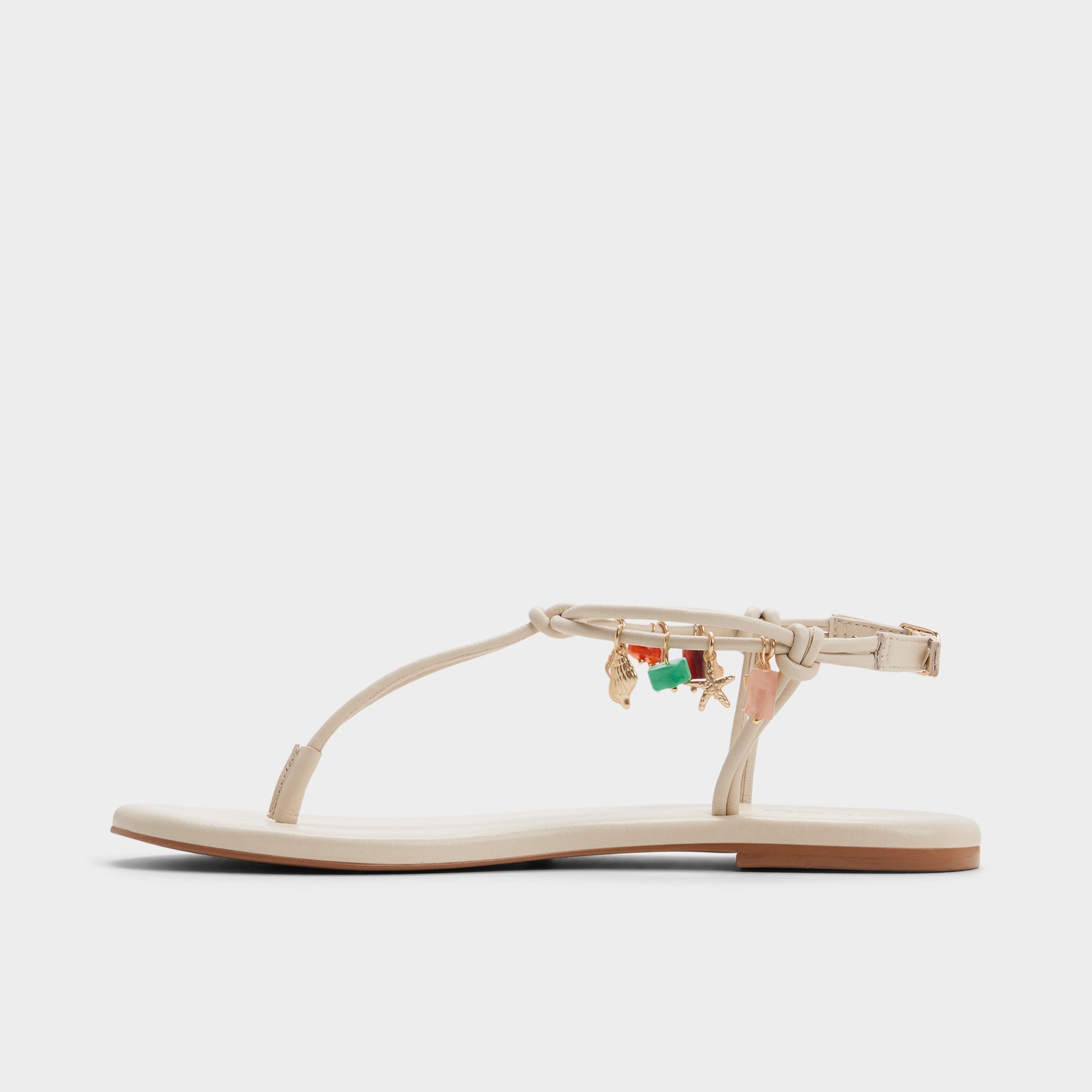 Side view of White/bone Seajewels T-strap sandal
