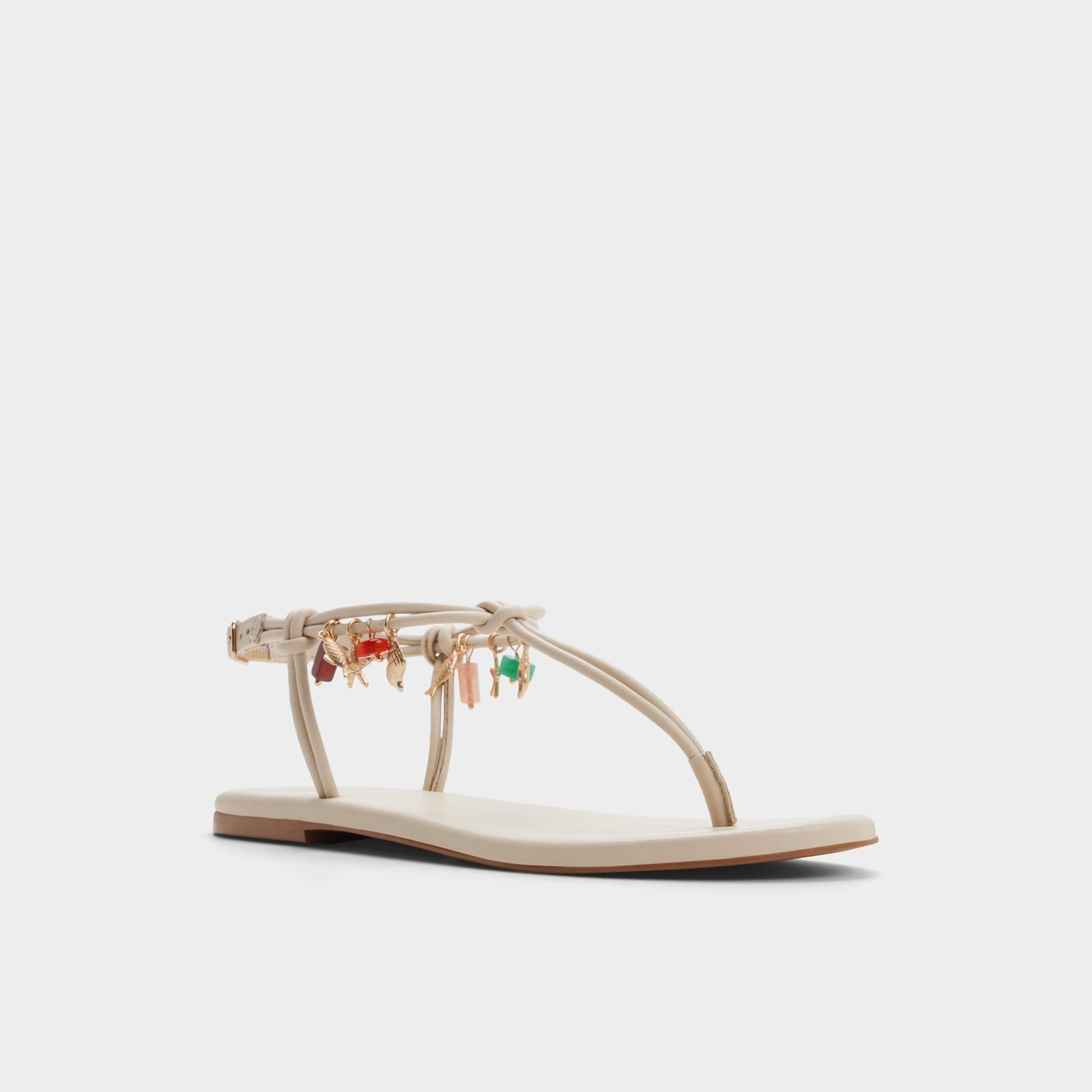 Three-quarter angle of White/bone Seajewels T-strap sandal's front side