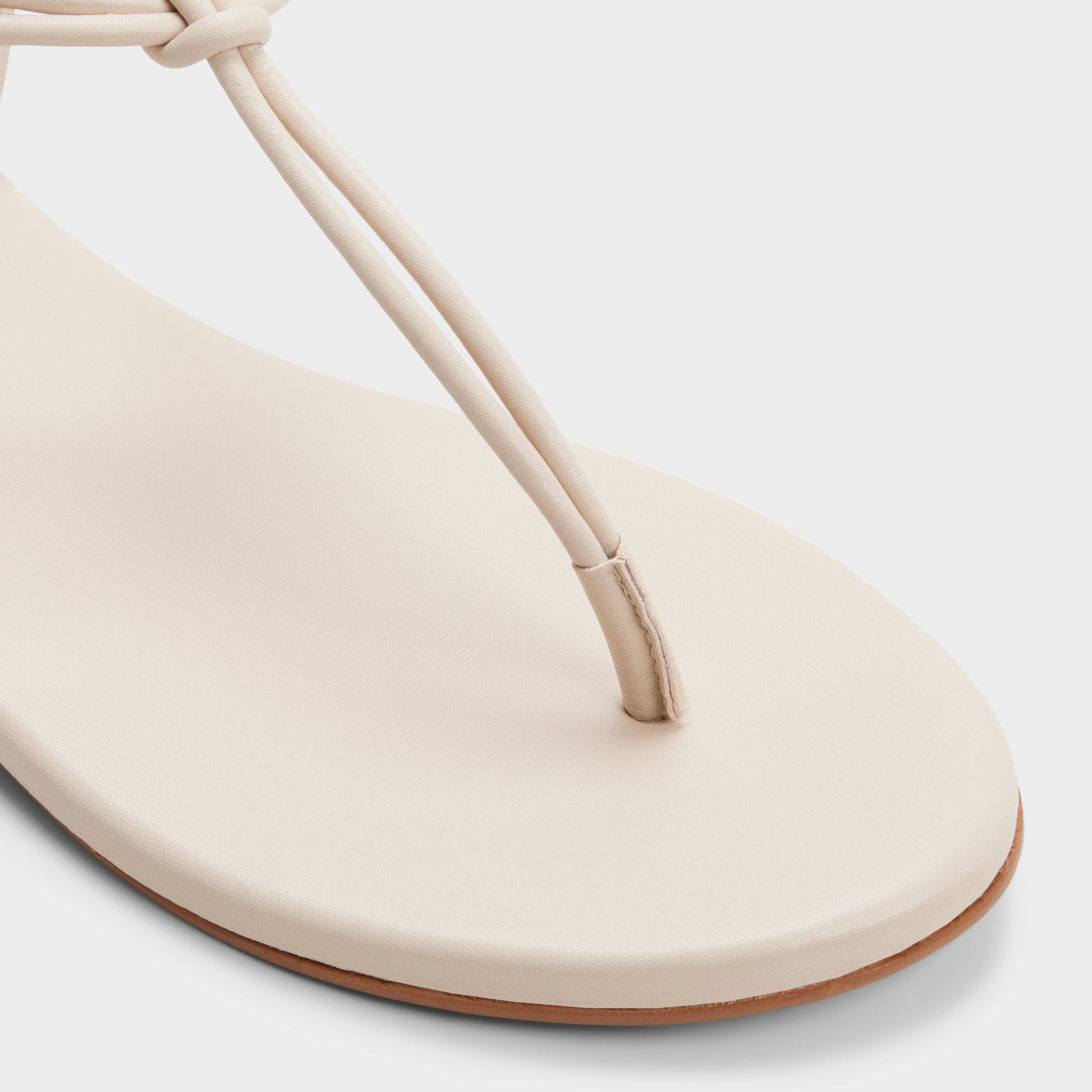 Close-up of the White/bone Seajewels T-strap sandal
