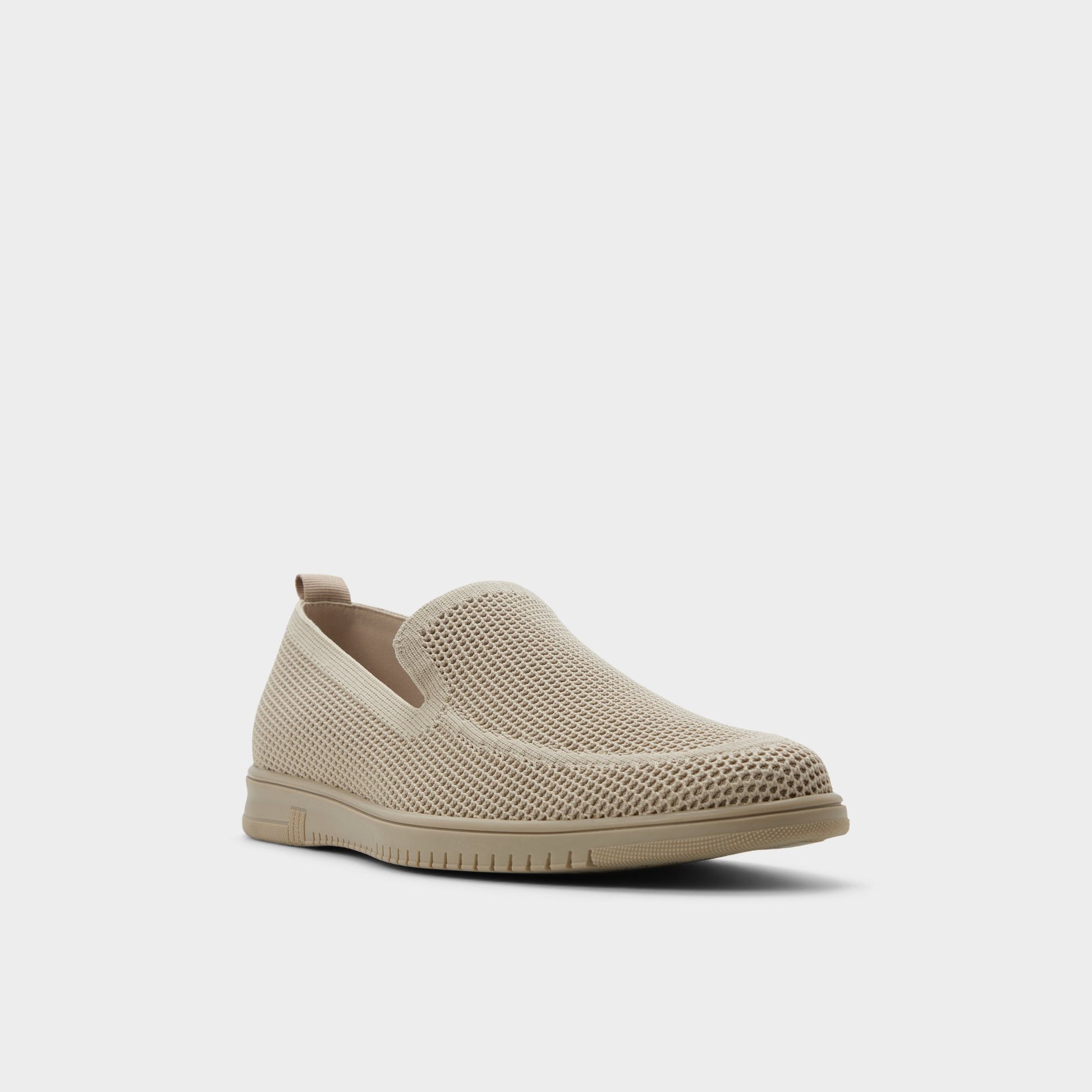 Three-quarter angle of Open beige Luxton Slip-on's front side