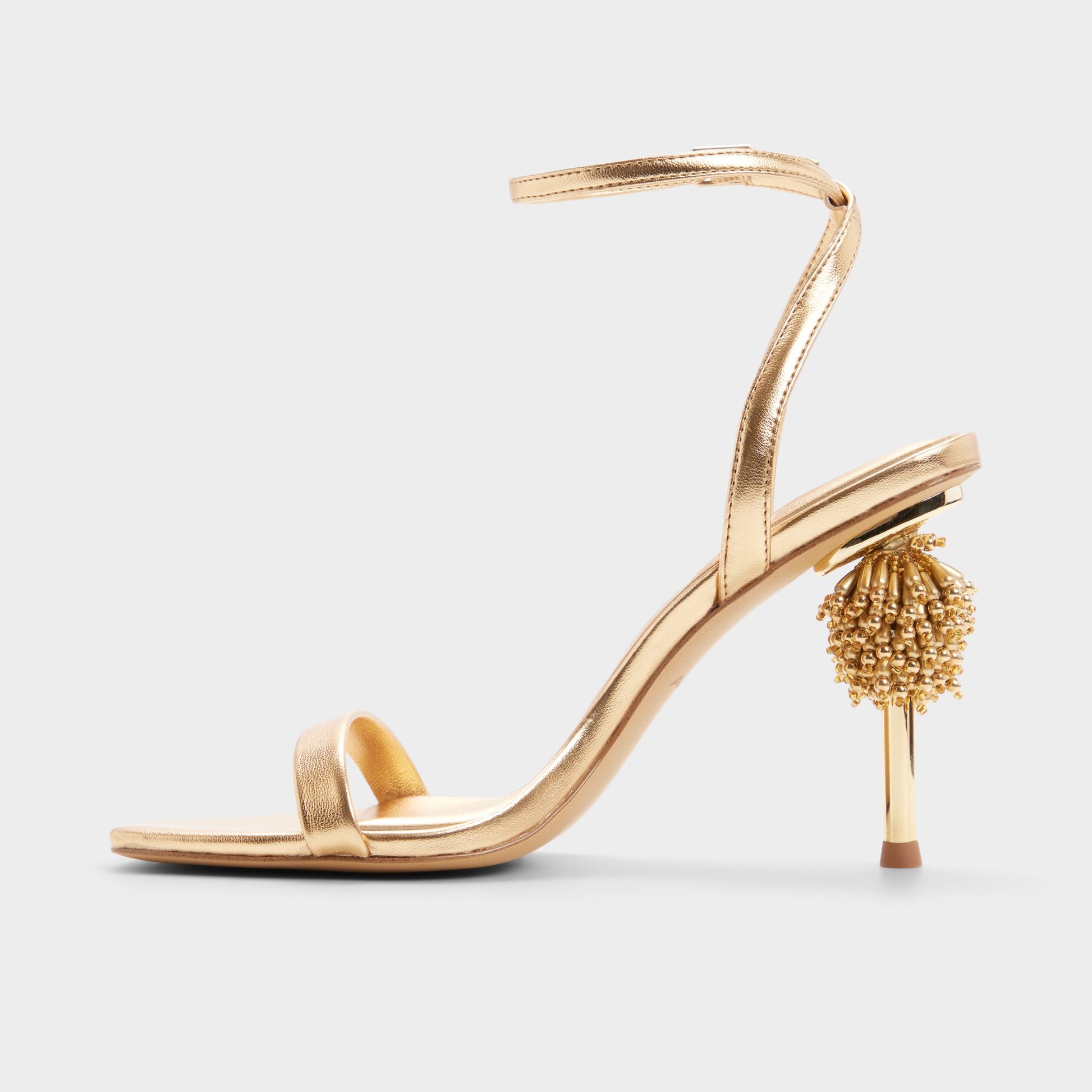 Side view of Gold Aurorae Strappy heeled sandal