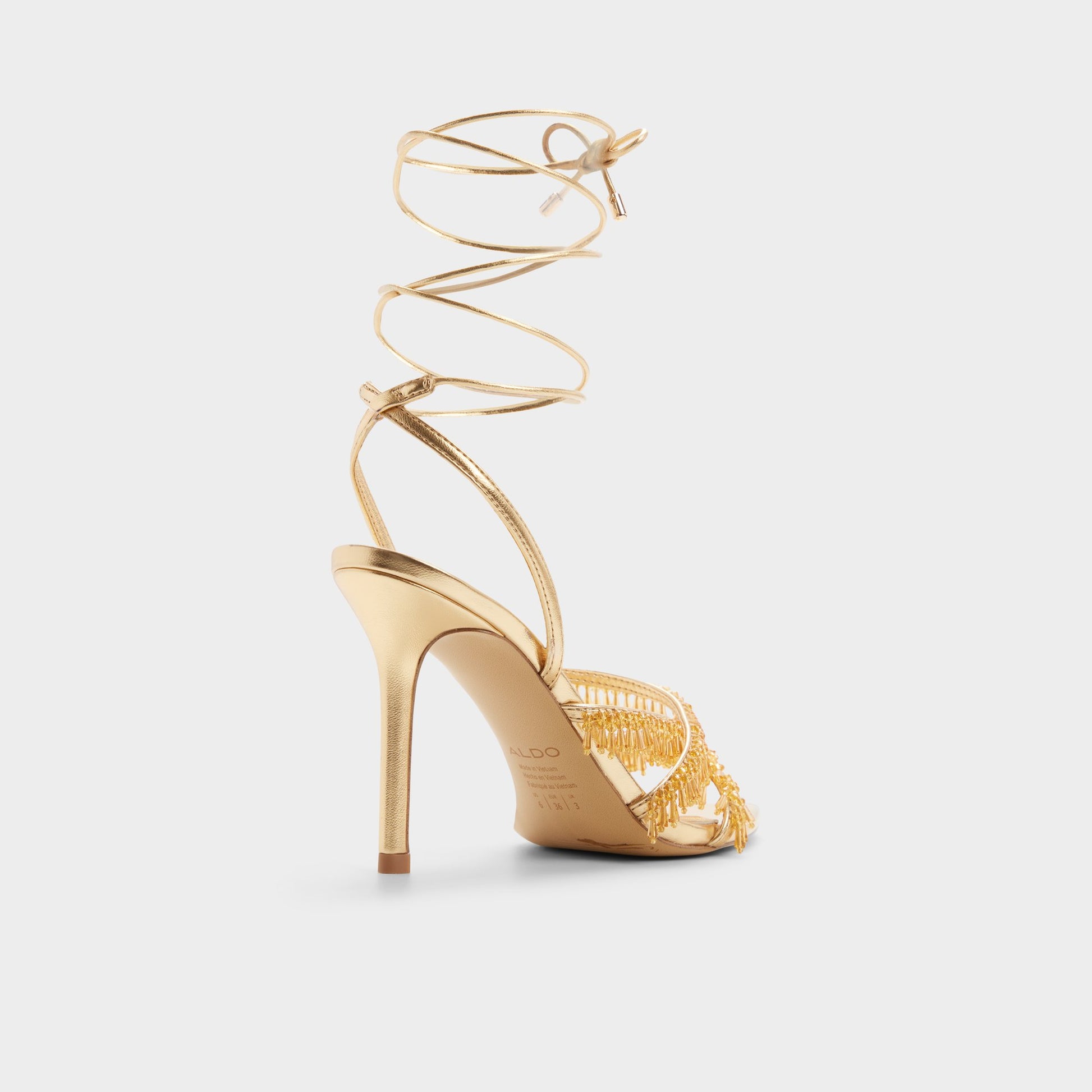 Three-quarter angle of Gold Flaming Strappy heeled sandal's back side