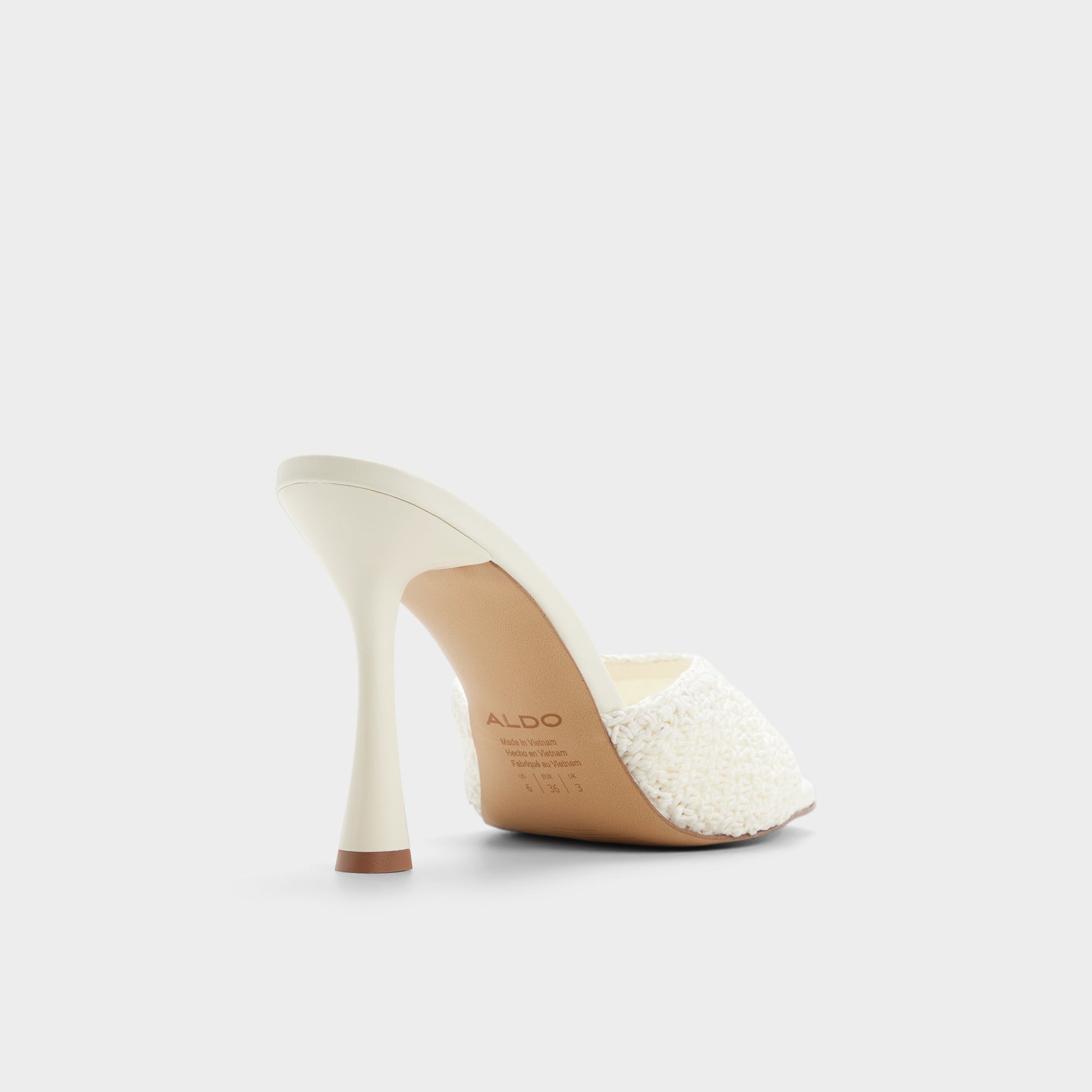 Three-quarter angle of White/bone Evadalie Heeled mule's back side