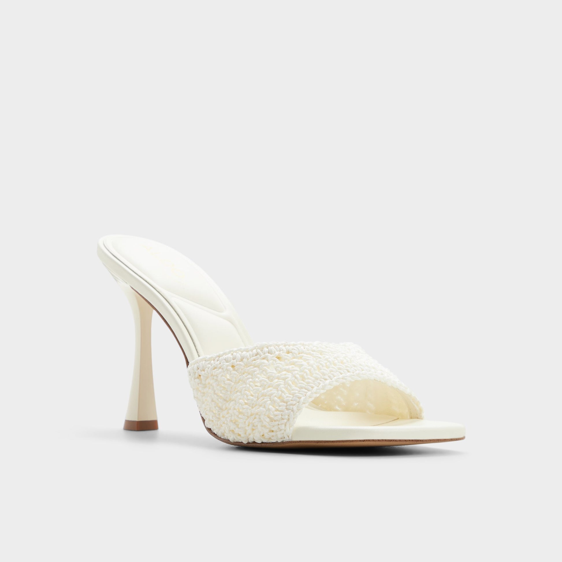 Three-quarter angle of White/bone Evadalie Heeled mule's front side