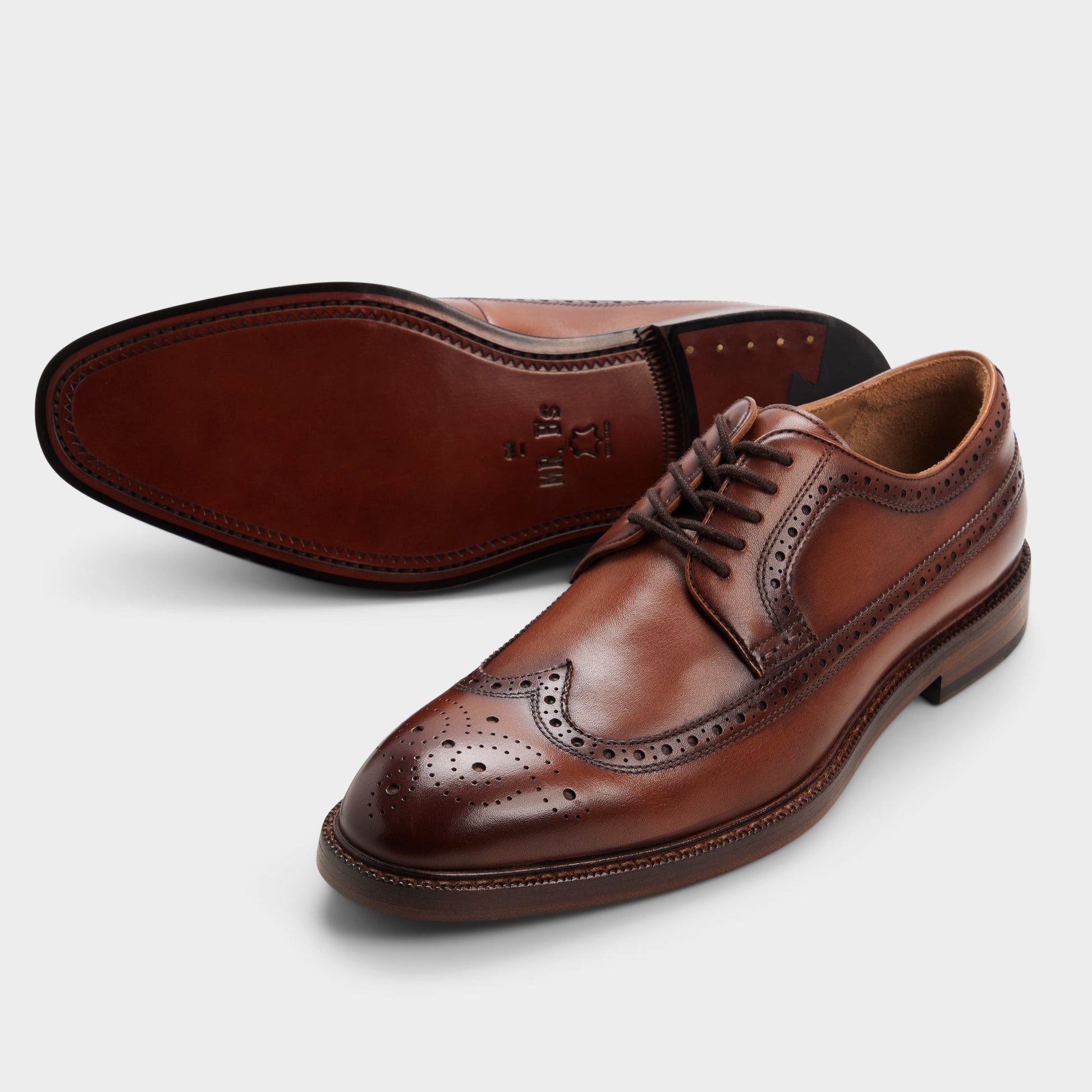 Highlighted view of a pair of Cognac Ricio Brogue lace-up shoes