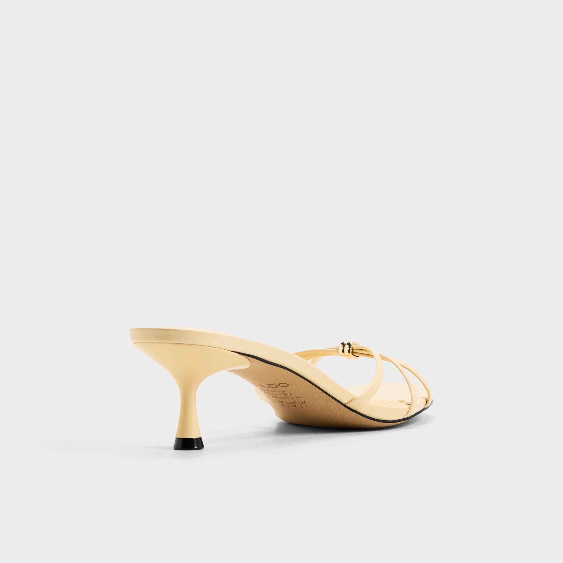 Three-quarter angle of Light yellow Madalyn Heeled mule's back side