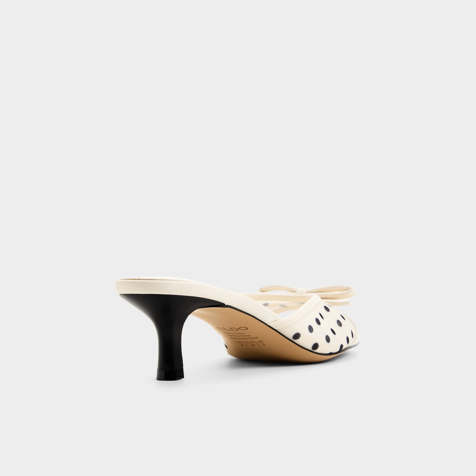 Three-quarter angle of White/black Begoniaa Heeled mule's back side