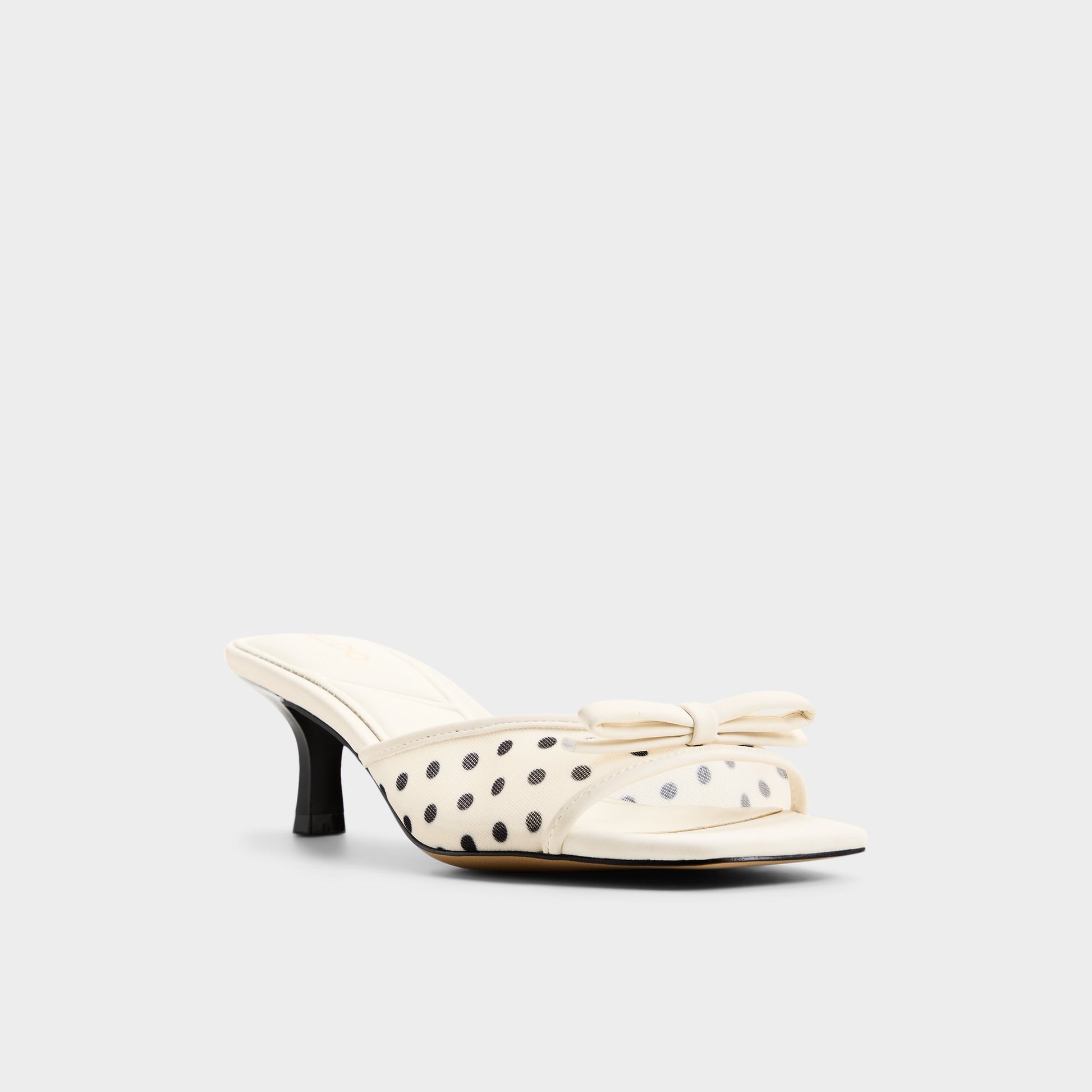 Three-quarter angle of White/black Begoniaa Heeled mule's front side