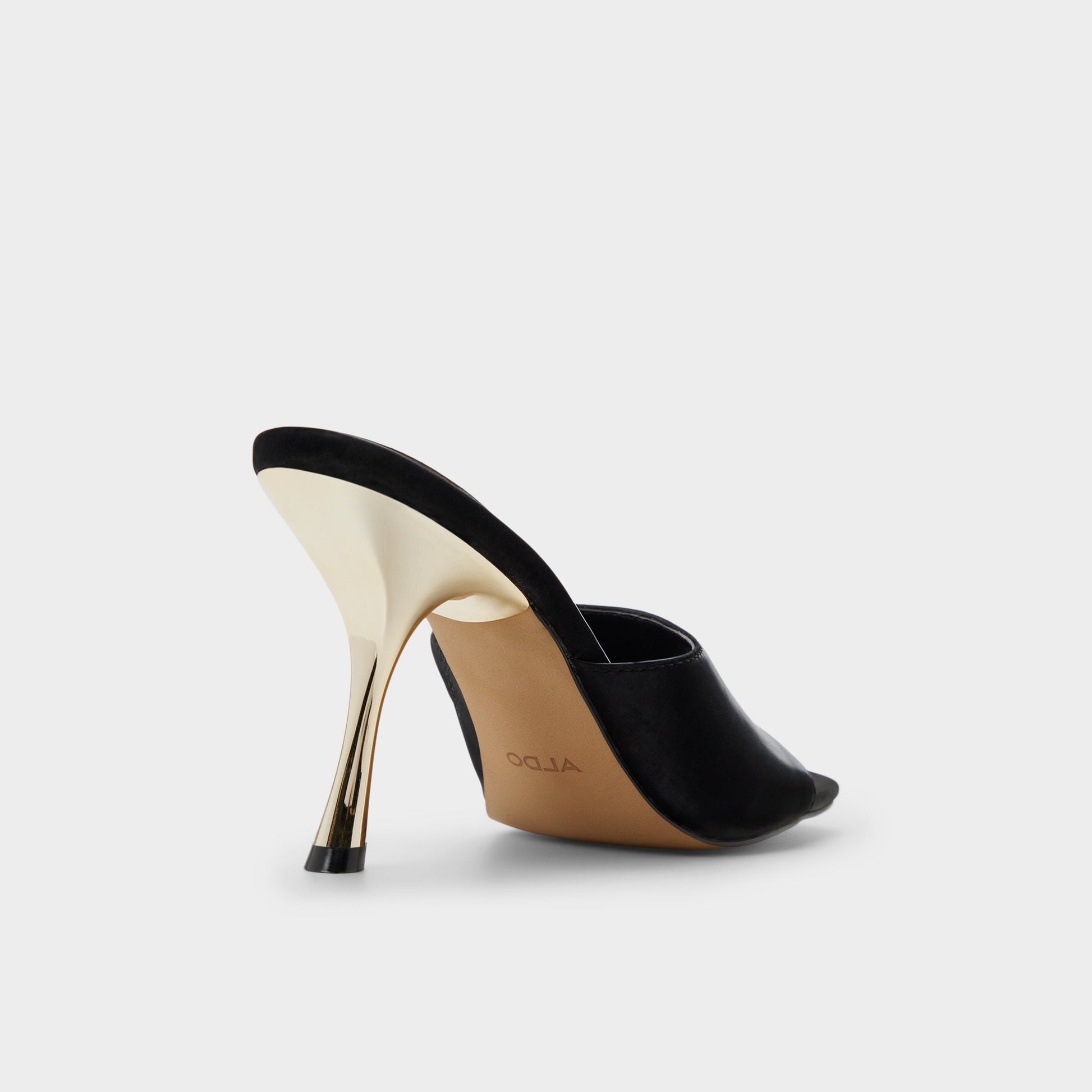 Three-quarter angle of Black Comacan Heeled mule's back side