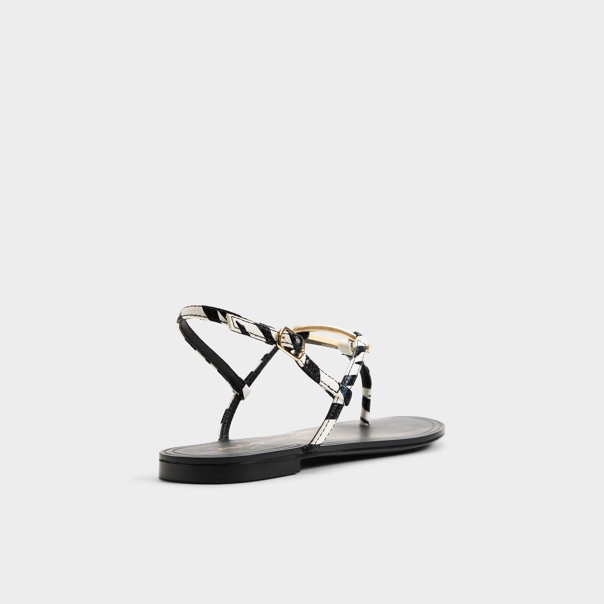Three-quarter angle of Black/white Alannah T-strap sandal's back side