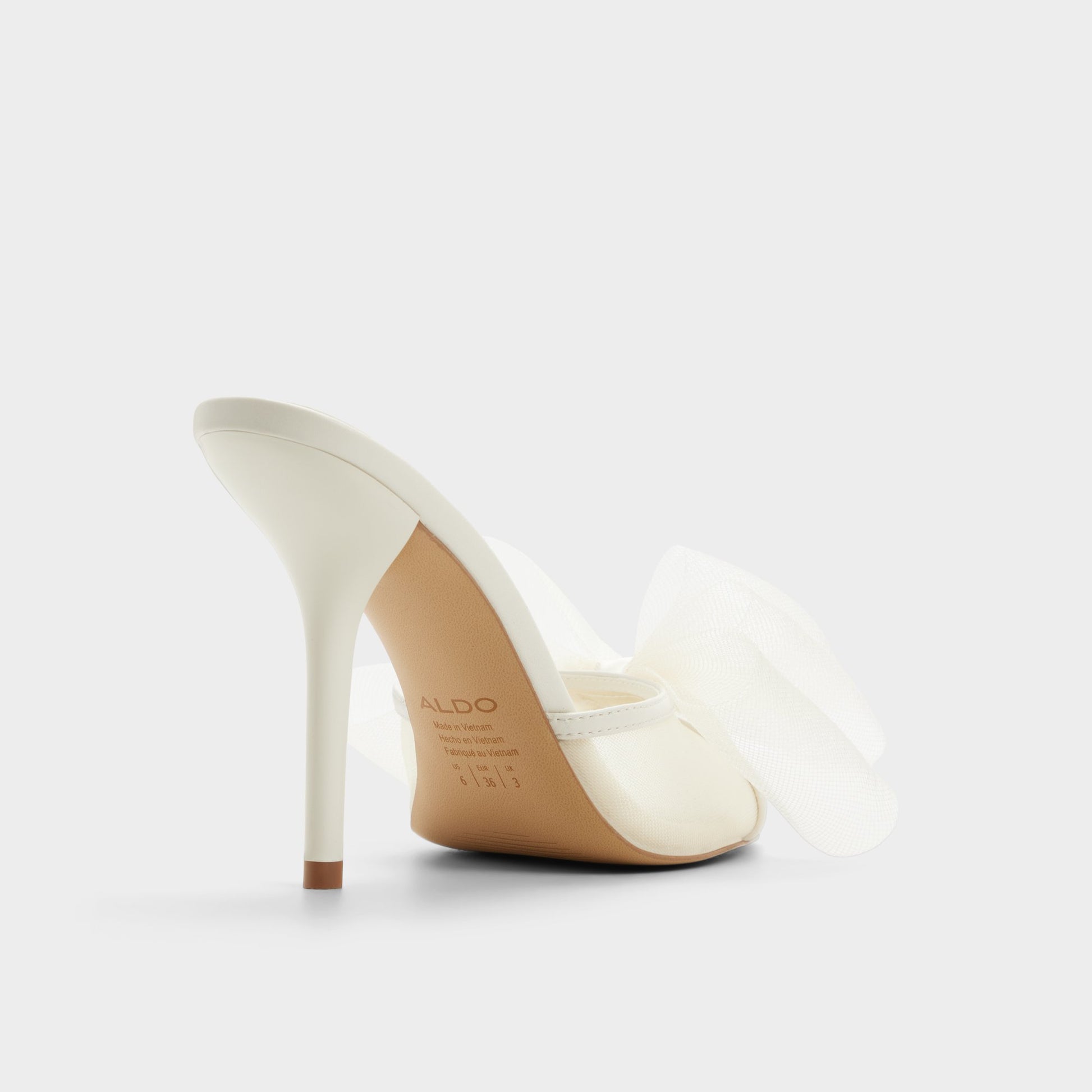 Three-quarter angle of White/bone Oceanne Heeled mule's back side