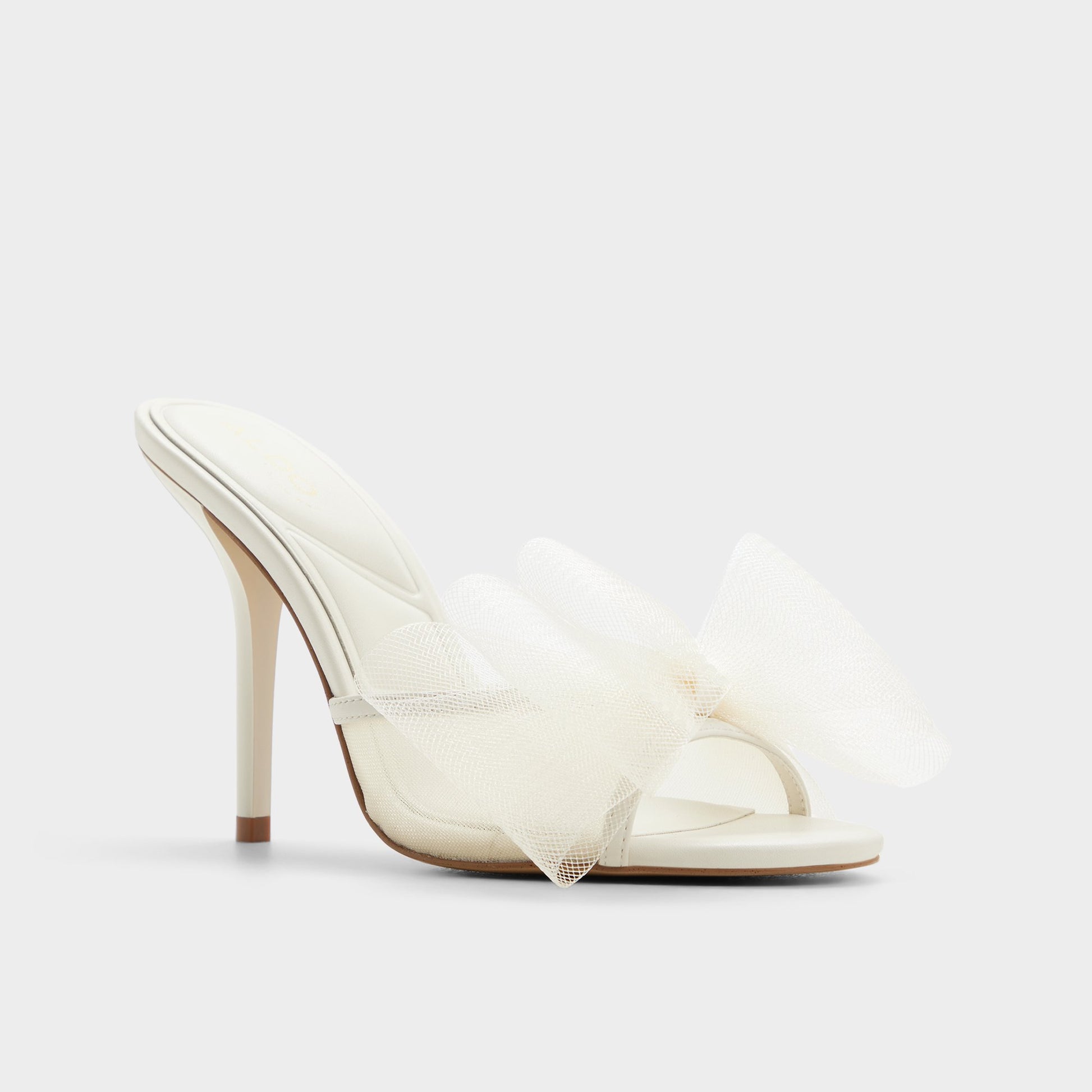 Three-quarter angle of White/bone Oceanne Heeled mule's front side