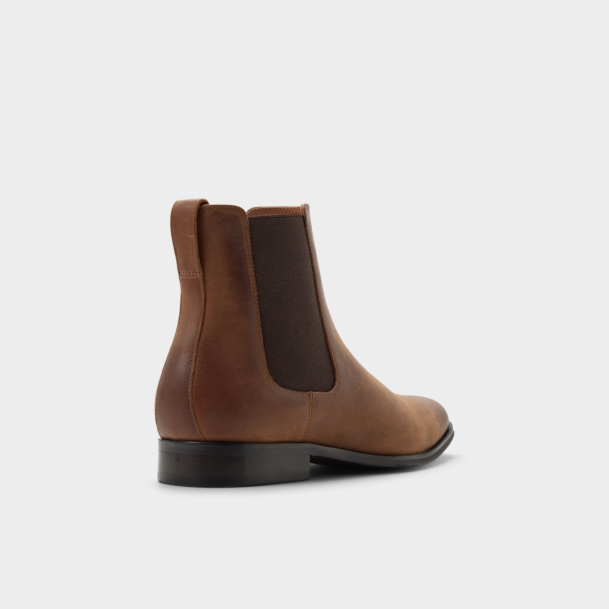 Three-quarter angle of Cognac Caspen Chelsea boot's back side
