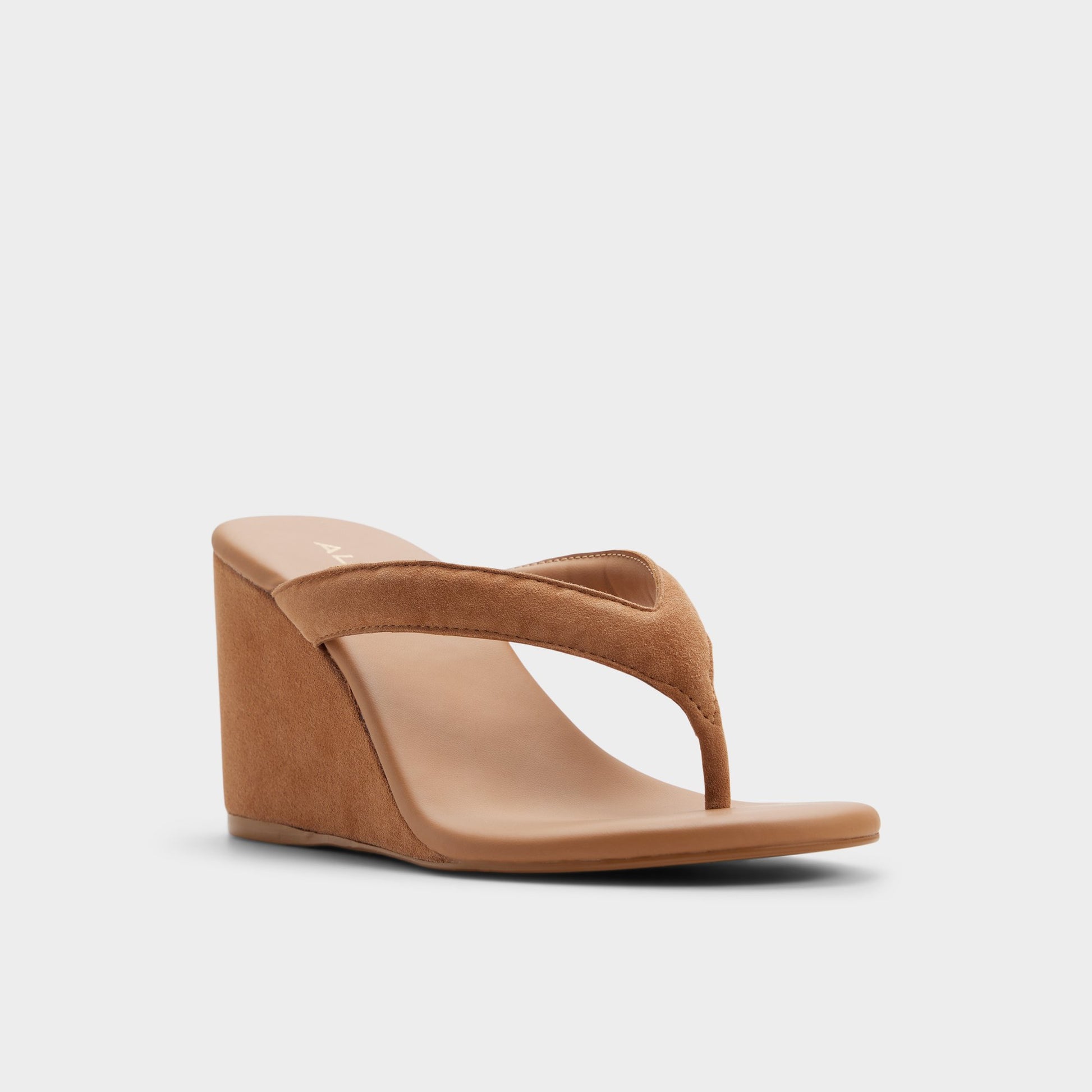 Three-quarter angle of Medium brown Isabelia Wedge thong sandal's front side