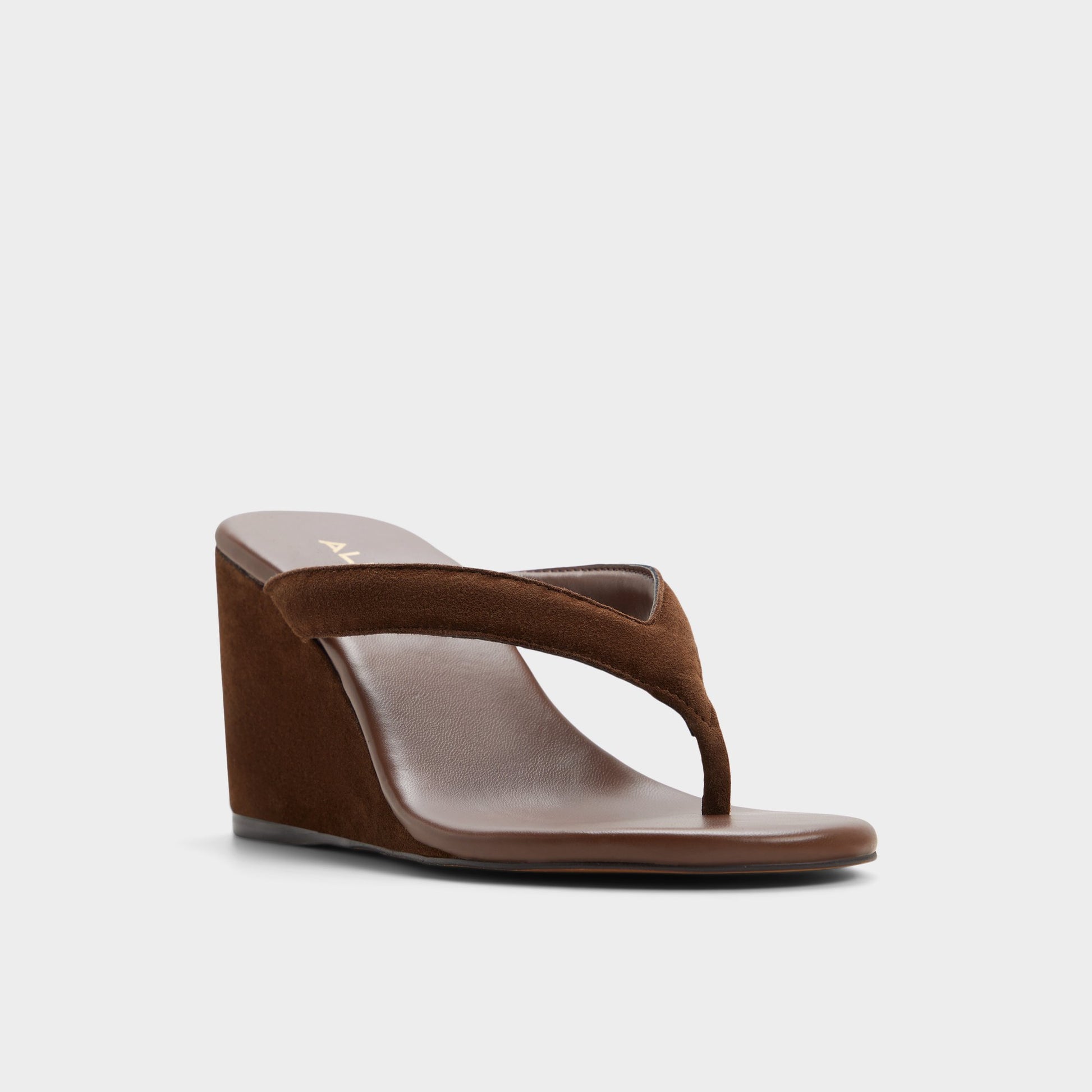 Three-quarter angle of Dark brown Isabelia Wedge thong sandal's front side