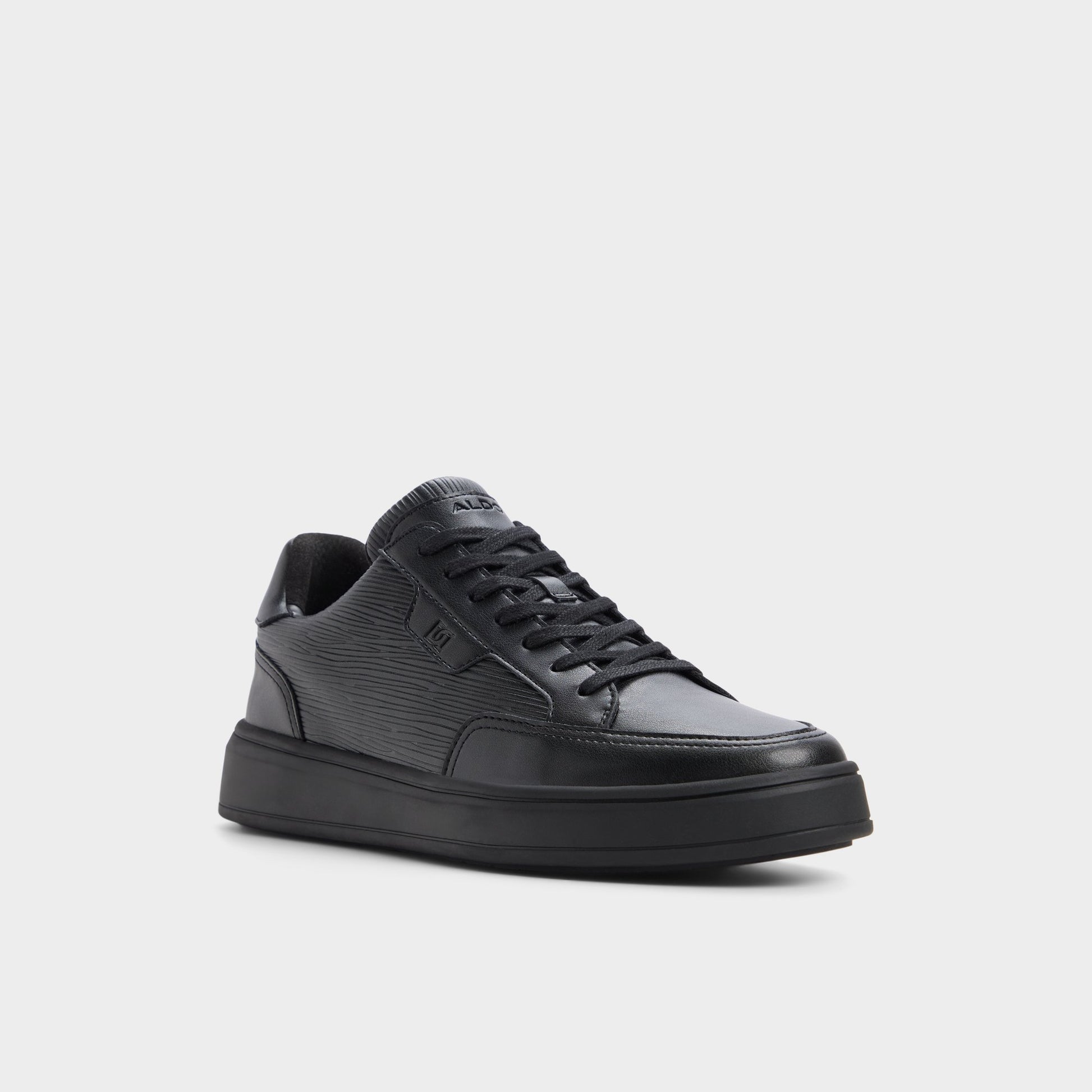 Three-quarter angle of Black/black Miko Low top sneaker's front side