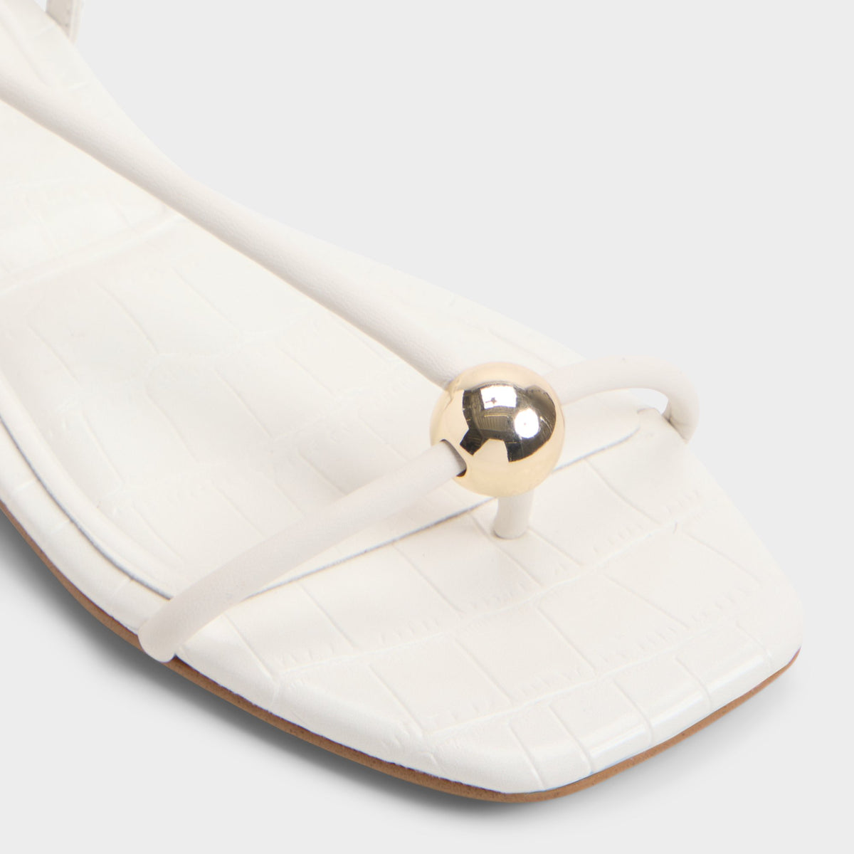 Close-up of the White/bone Zaelle Strappy flat sandal