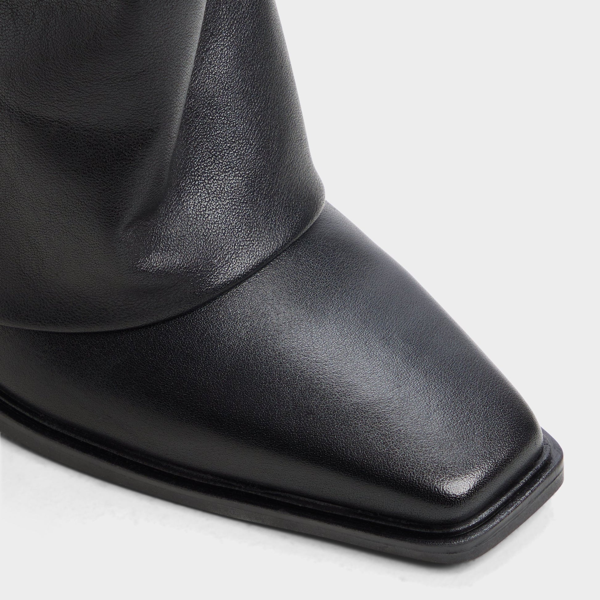 Close-up of the Black Amelle Block heel knee-high boot