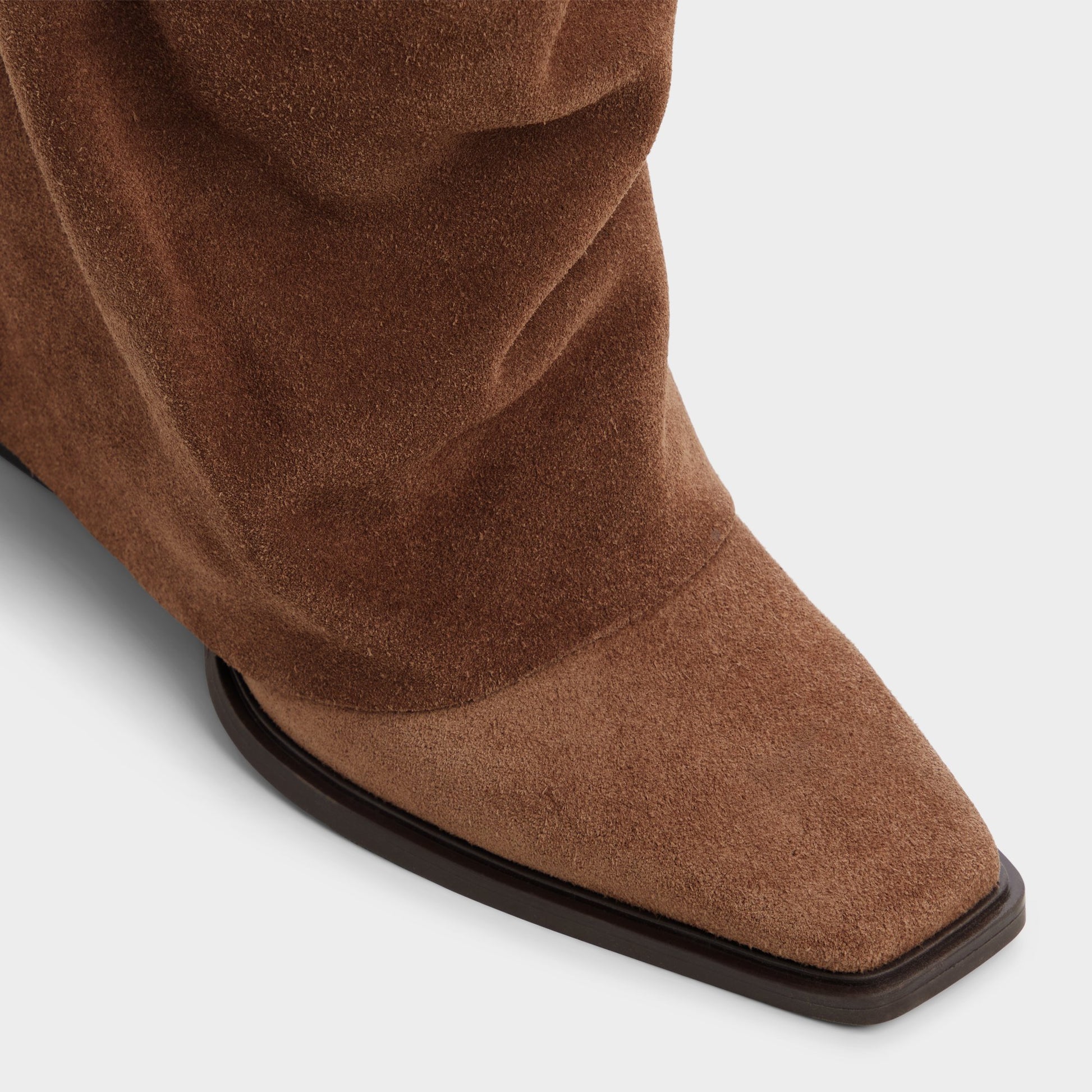 Three-quarter angle of Dark brown Amelle Block heel knee-high boot's front side
