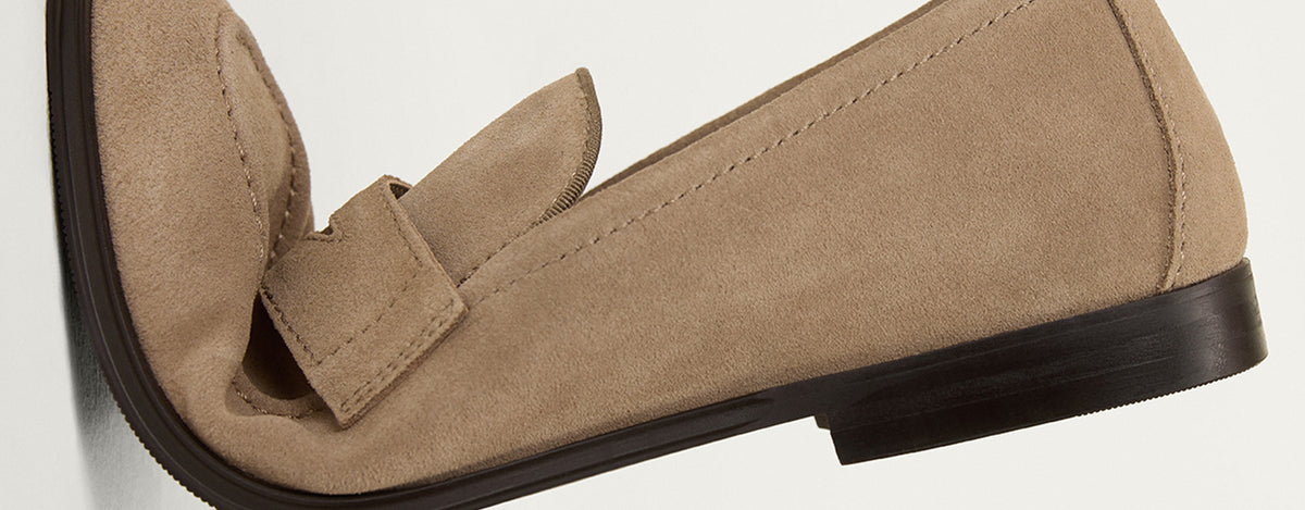 Beige loafer shoe on a light gray background