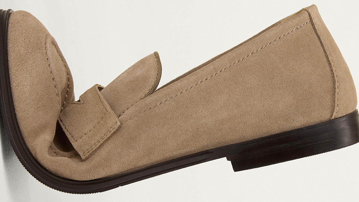 Beige loafer shoe on a light gray background