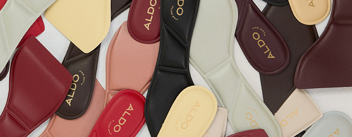 Collection of ALDO branded shoe cushioned soles on a white background.