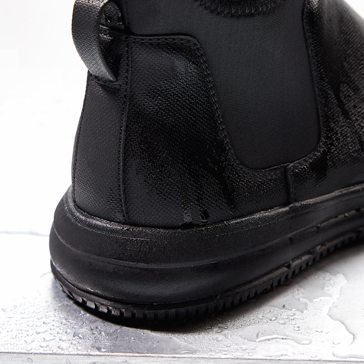 Close-up of a black boot on a light gray background