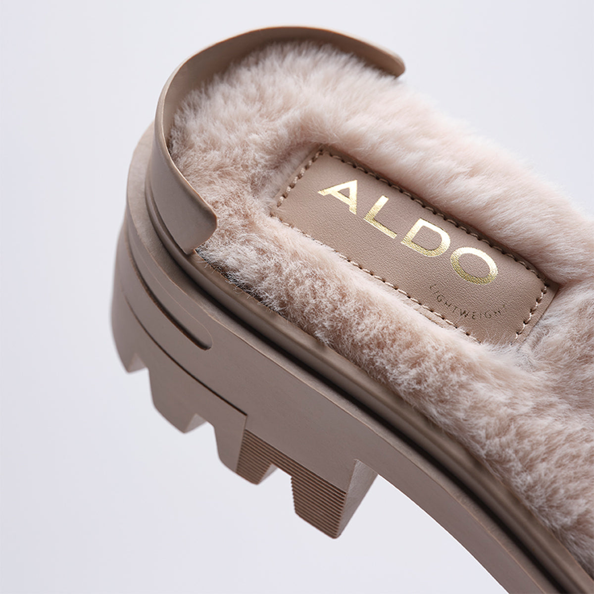 Close-up of a shoe with ALDO branding on a light background